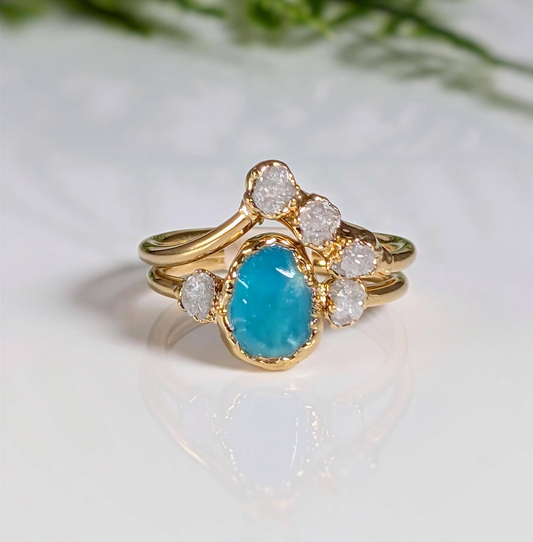 Raw Peruvian Opal and diamond engagement ring set in gold, showcasing a stunning aqua-blue opal and sparkling diamonds.