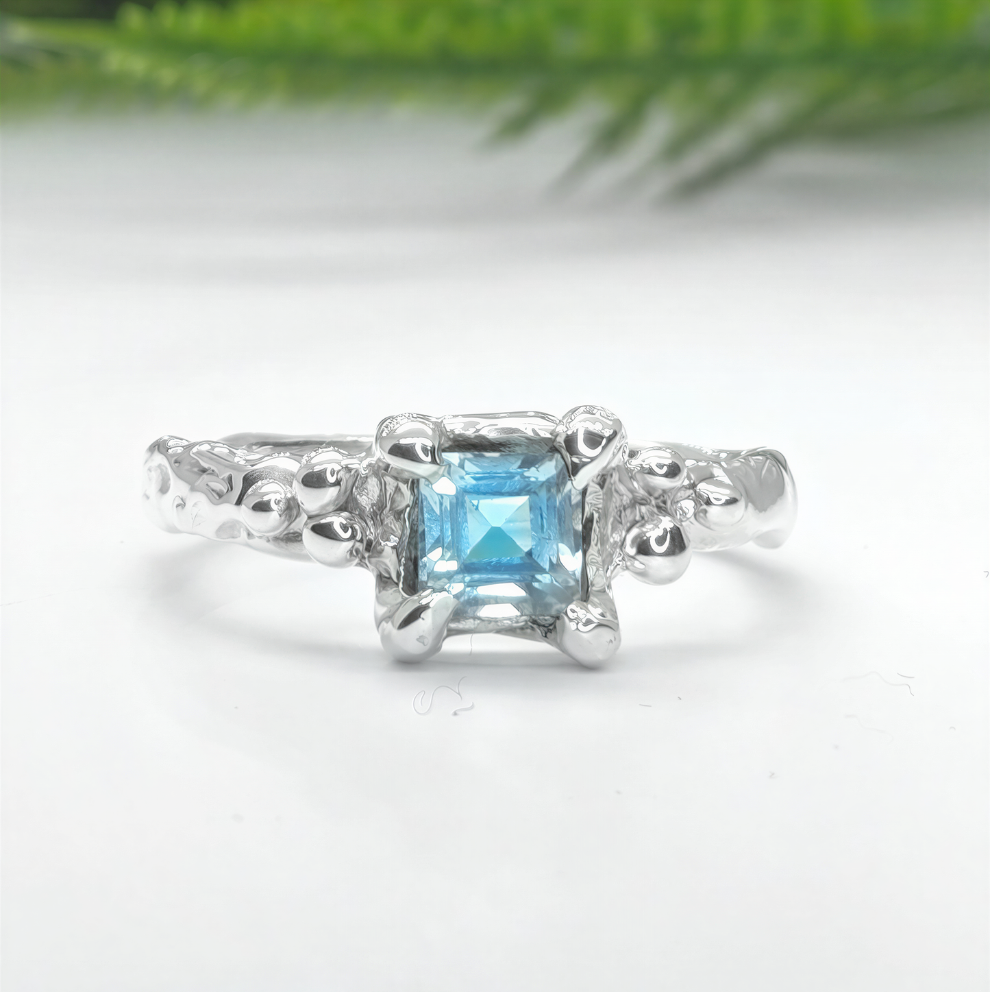 Solid 14k gold engagement ring featuring a unique London Blue Topaz in an organic textured band.