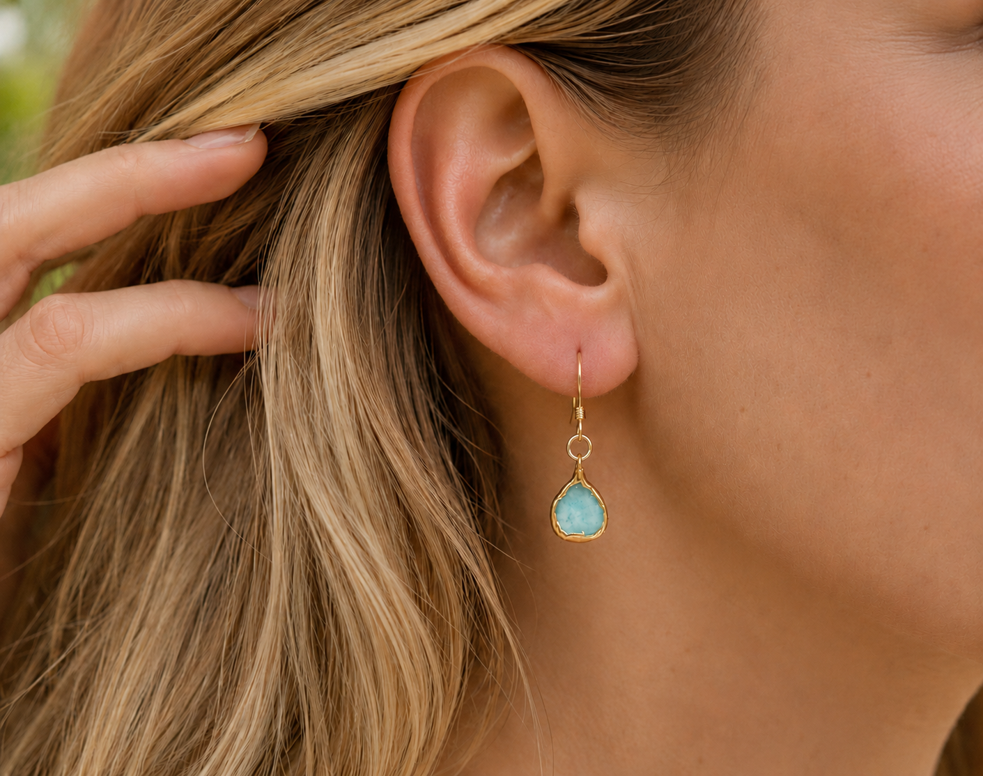 Woman wearing a light blue Amazonite earrings
