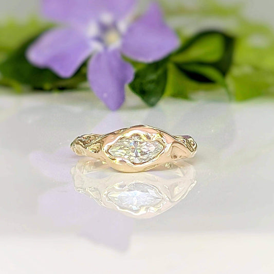 Moissanite Engagement Ring - Solid 14k Gold Textured Band featuring a marquise stone and a textured band.
