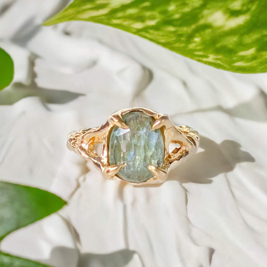 Solid 14k Gold textured ring featuring a stunning oval rose cut Green Kyanite on a natural background.