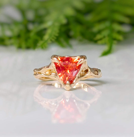 Orange Sapphire trilliant cut ring in solid 14k gold with unique molten texture, perfect for engagement or special gift.