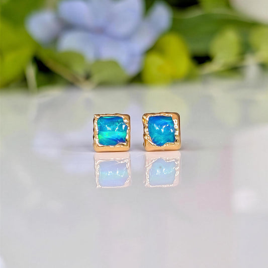 A pair of square shape flashy blue & green Opal stud earrings in Gold organic setting
