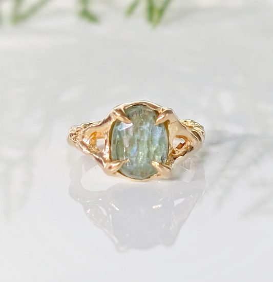 Solid 14k Gold textured ring featuring an oval Lime green Kyanite stone, showcasing unique artistry and elegance.