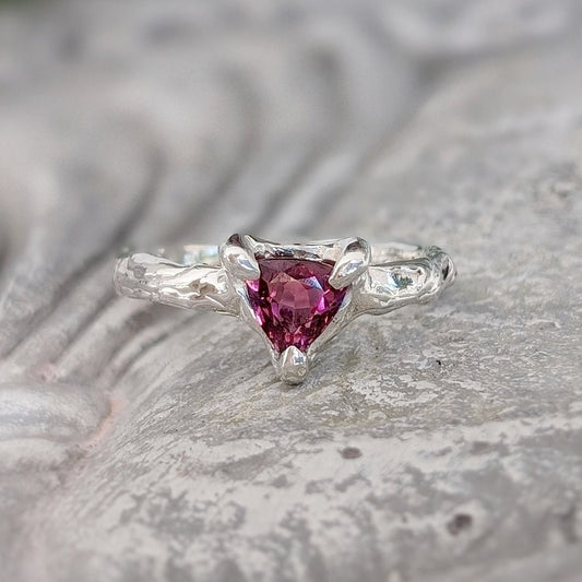 Handcrafted silver ring featuring a dark pink Rubellite Tourmaline gemstone on an organic textured band.