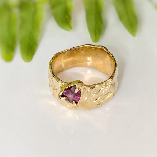 Handcrafted solid 14k gold textured ring featuring a pear-shaped pink Rubellite Tourmaline, elegant nature-inspired design.