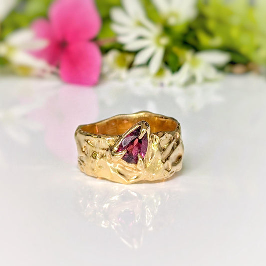 Handcrafted textured solid gold ring featuring a pear-shaped pink Rubellite Tourmaline, nature-inspired elegance.