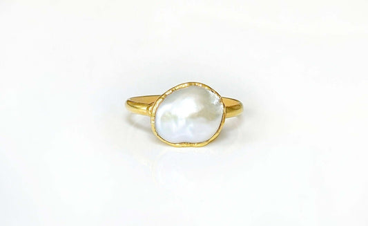 A Solid 14k Gold ring featuring a large Freshwater Pearl