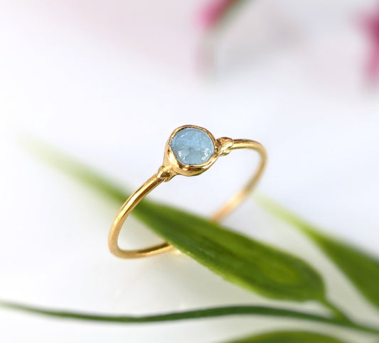 Dainty aquamarine stacking ring with a natural 4mm stone set on a gold filled band, perfect for everyday wear.