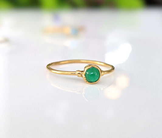 Dainty emerald stacking ring featuring a natural green emerald gemstone on a 14k gold filled band.