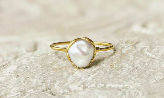 Small freshwater Keshi pearl ring on solid 14k gold band, showcasing simple elegance and handcrafted beauty.