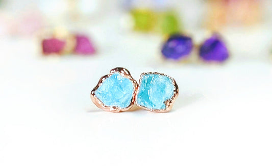 Dainty raw Aquamarine stud earrings in 18k gold setting, showcasing unique rough stone shapes.