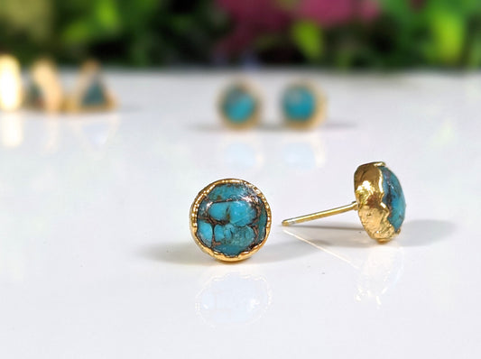 Close-up of turquoise stud earrings featuring 10mm round copper stones on gold posts, showcasing elegant design.
