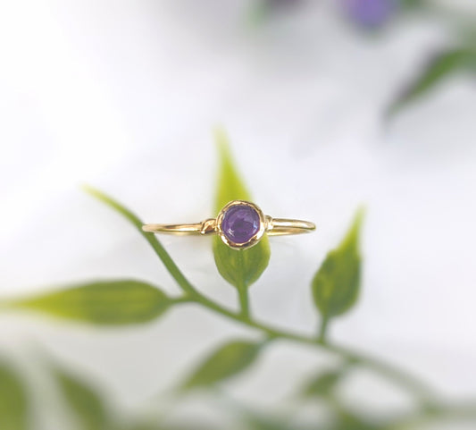 Dainty gold stacking ring featuring a 4mm natural purple Amethyst gemstone, perfect for minimalist jewelry lovers.
