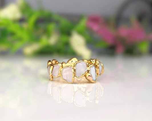 Rose Quartz eternity ring with gold filled band showcasing contrasting shapes and colors of gemstones.