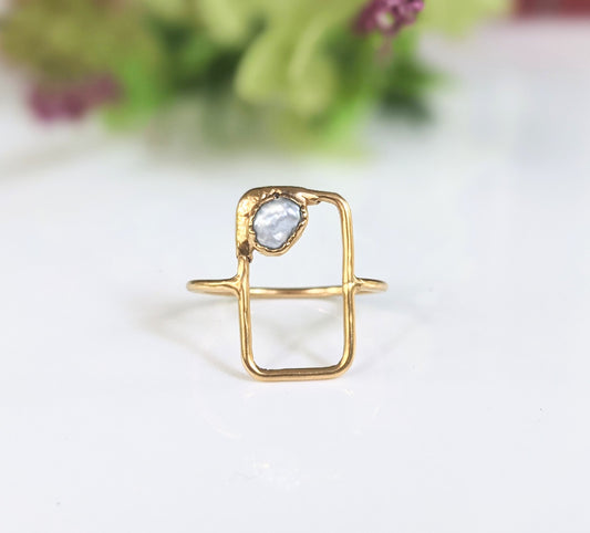 Geometric freshwater pearl ring in solid 14k gold with a unique design and natural pearl accent.