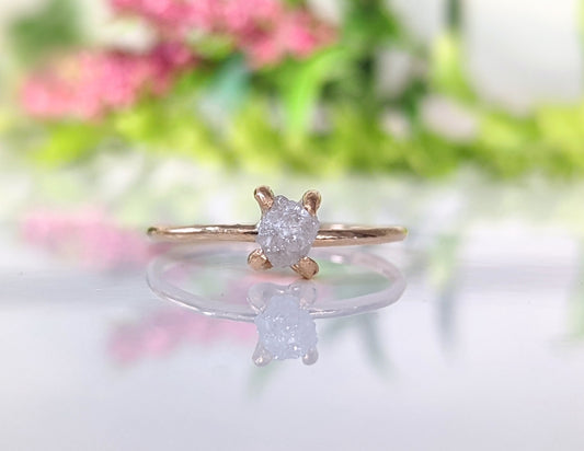 Delicate raw diamond engagement ring with 5-6mm conflict-free stone, set in a solid 14k gold prong band.