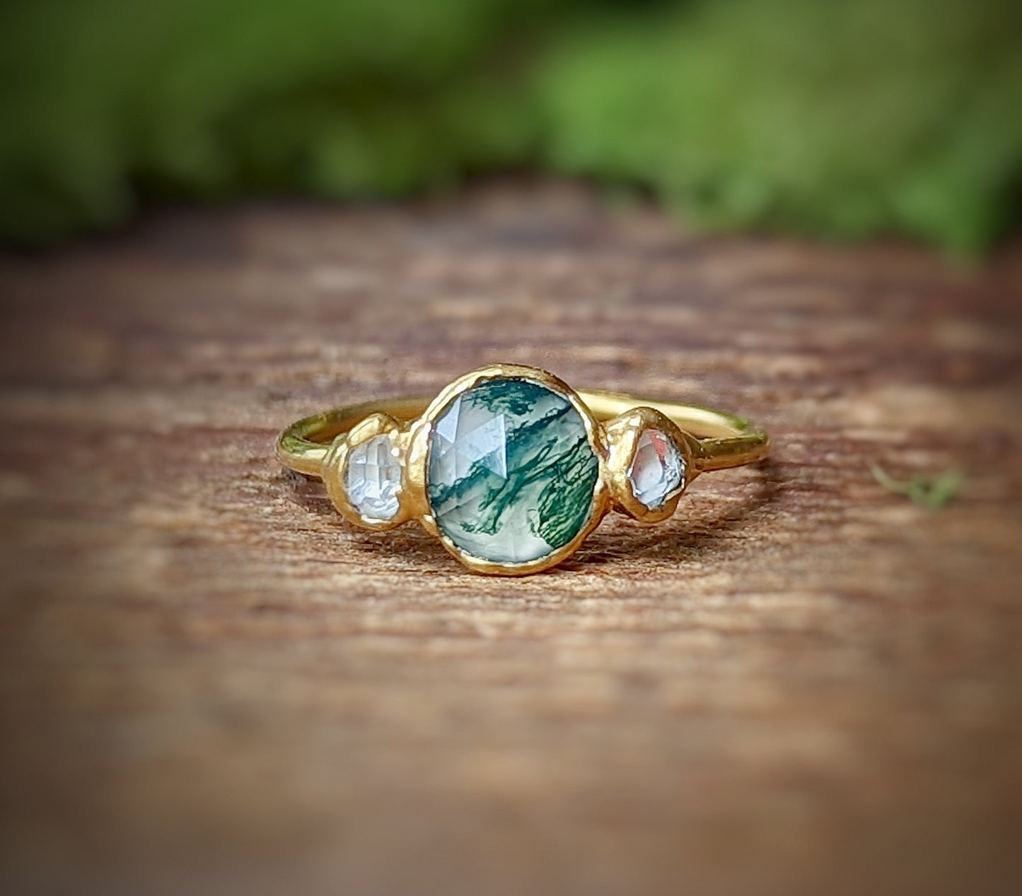 Moss Agate and Herkimer diamond engagement ring on gold band showcasing unique craftsmanship and organic beauty.