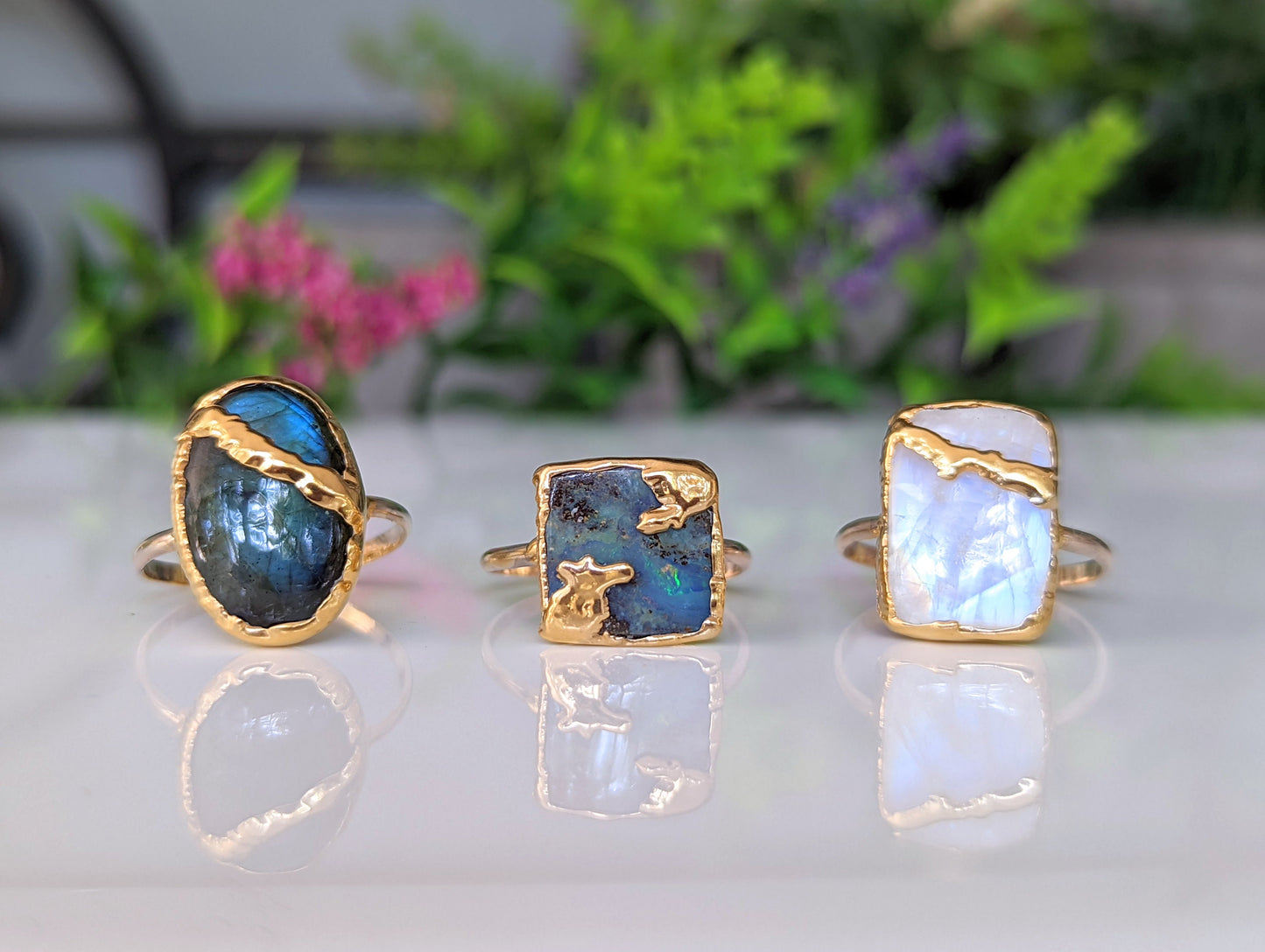 Handcrafted Kintsugi rings featuring Rainbow Moonstone, labradorite, and peacock opal in gold settings.