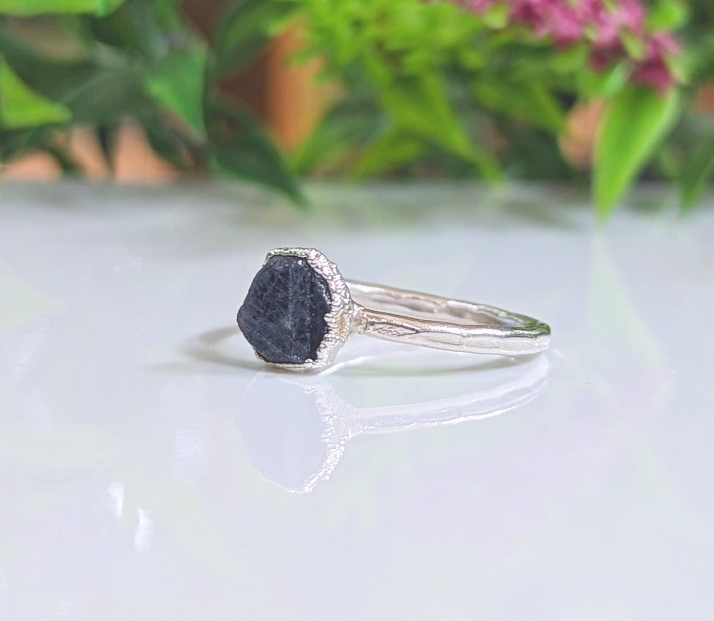 Raw sapphire and diamond Chevron ring on a silver band, showcasing unique handcrafted design.