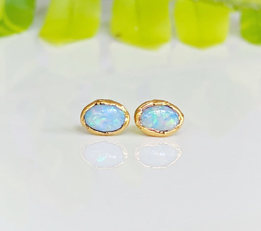 Light blue Australian Opal stud earrings set in 18k gold, perfect for bridal or special occasion gifts.