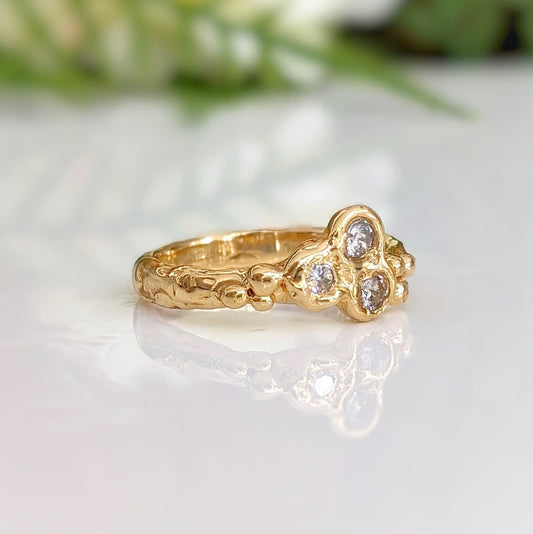 Cubic Zirconia cluster ring in solid 14k gold with organic textured band, showcasing brilliant stones.