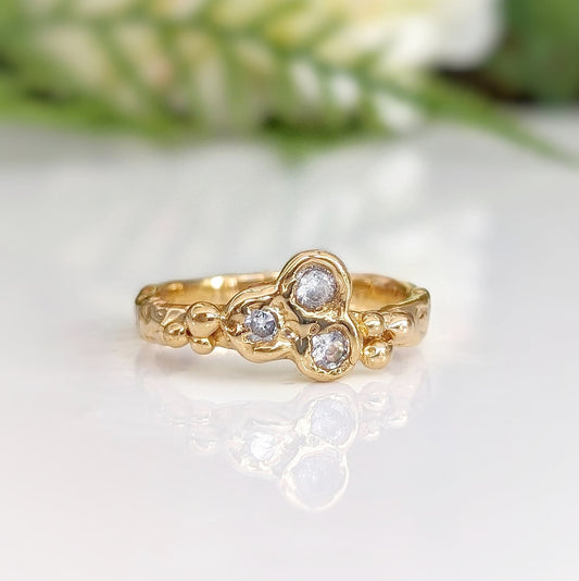 Cubic Zirconia cluster ring in solid 14k gold with an organic textured band and sparkling stones.