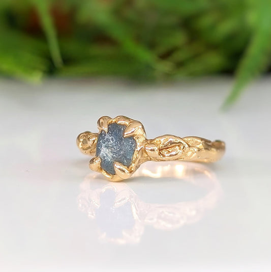 Raw Montana Sapphire engagement ring in solid 14k gold, showcasing organic texture and unique design.