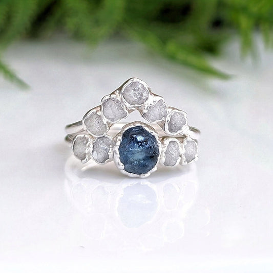 Raw Montana sapphire and diamond bridal ring set in sterling silver, featuring a teal blue sapphire and raw diamonds.