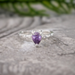 Amethyst engagement ring in solid sterling silver with pear-shaped gemstone on a textured band.