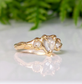 Rustic textured gold engagement ring featuring unique Salt & Pepper diamonds in a romantic design.
