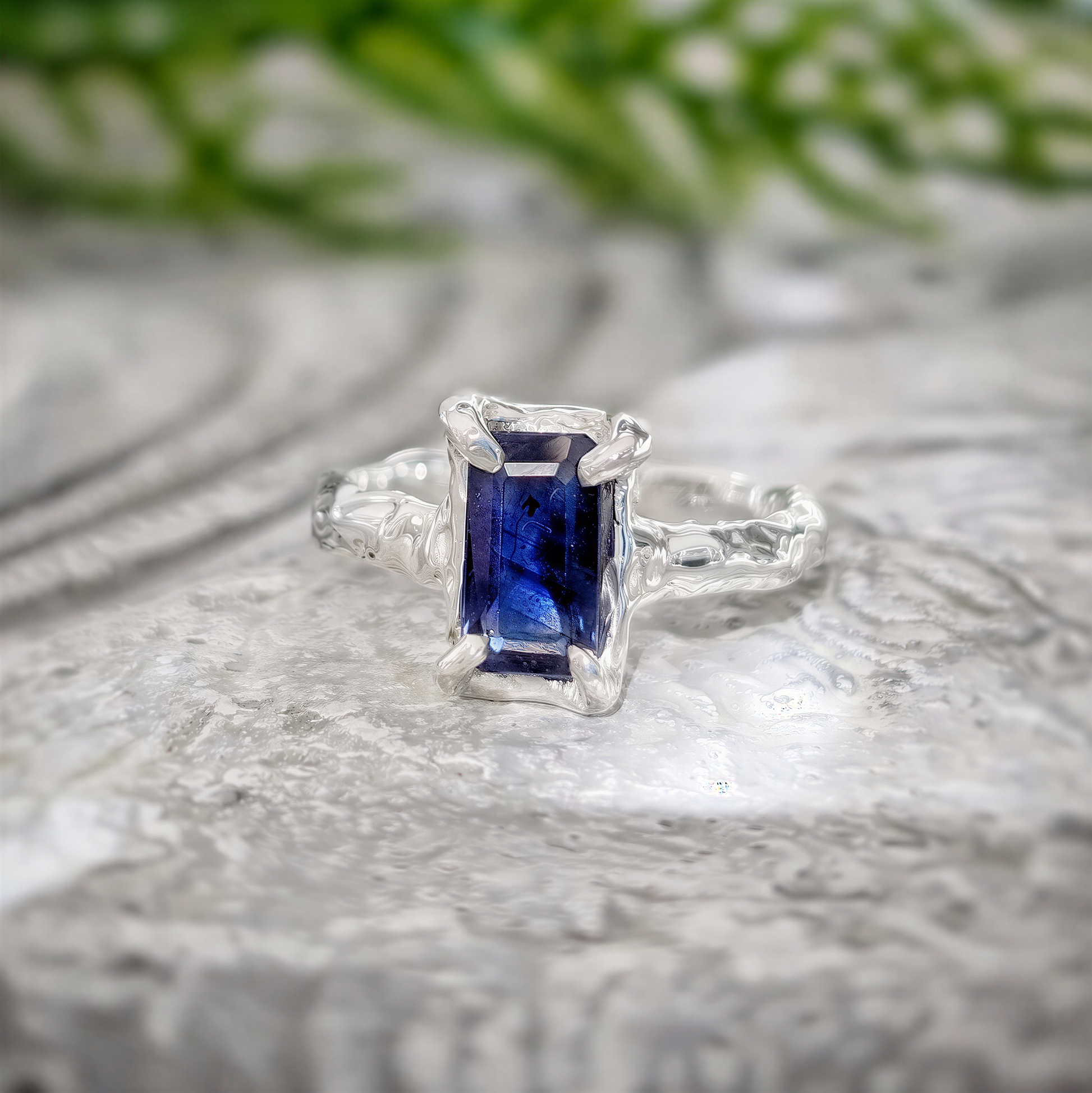 Emerald cut blue lab-created Sapphire engagement ring in solid 14k gold with organic texture.