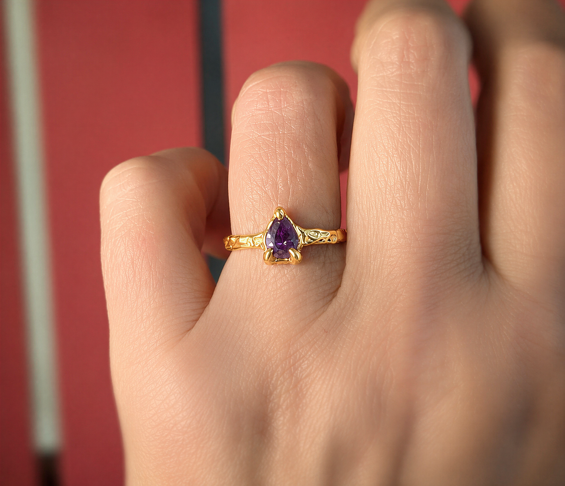 Solid Gold textured Amethyst ring on a woman's hand