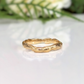 Handcrafted molten gold stacking ring showcasing a unique organic design, perfect as a wedding band or statement piece.