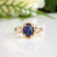 Close-up of natural blue sapphire and silver-white raw diamonds in textured gold