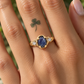 Blue sapphire and diamond engagement ring on a woman's hand, showcasing unique design and timeless elegance.