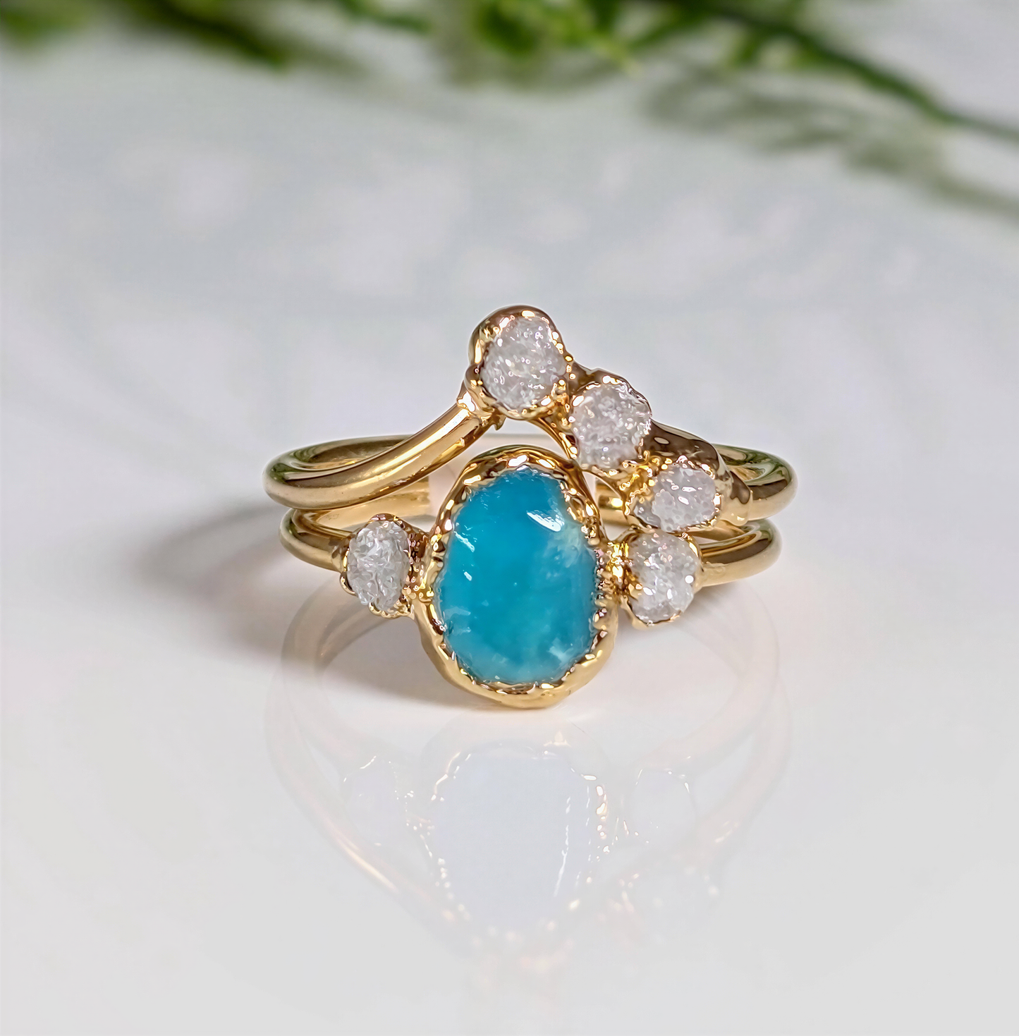 Raw Peruvian Opal and diamond engagement ring set in gold, showcasing a stunning aqua-blue opal and sparkling diamonds.