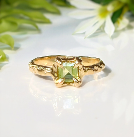 Solid 14k gold handcrafted Peridot ring with organic textured band and princess-cut gemstone.