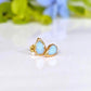 A pair of pear-shape white australian opal stud earrings in gold textured setting. The opals have lovely flashes of color.