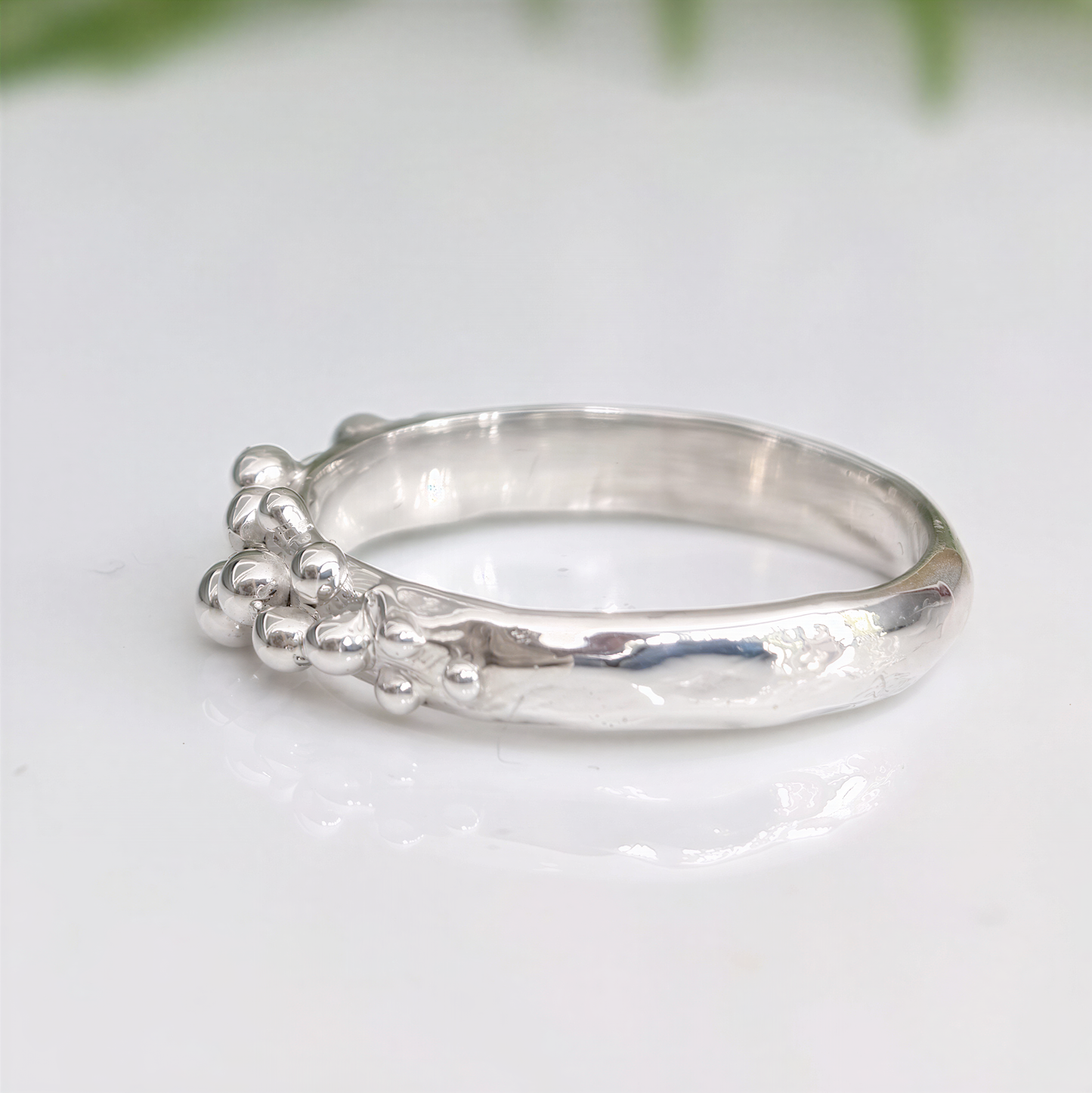 Dew Drop textured silver ring with beaded details, showcasing handcrafted imperfections and unique design.