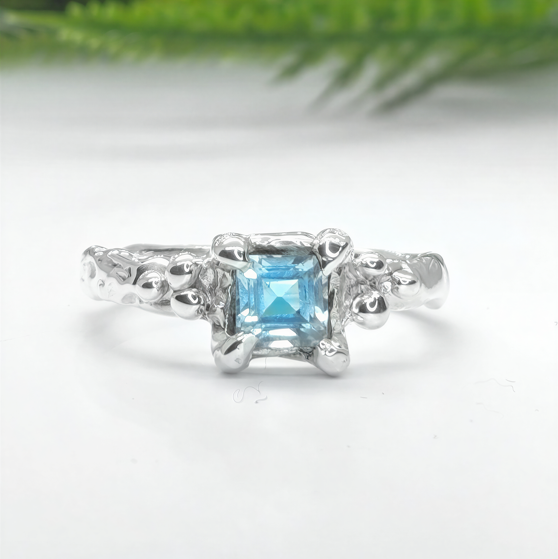 Solid 14k gold engagement ring featuring a unique London Blue Topaz in an organic textured band.