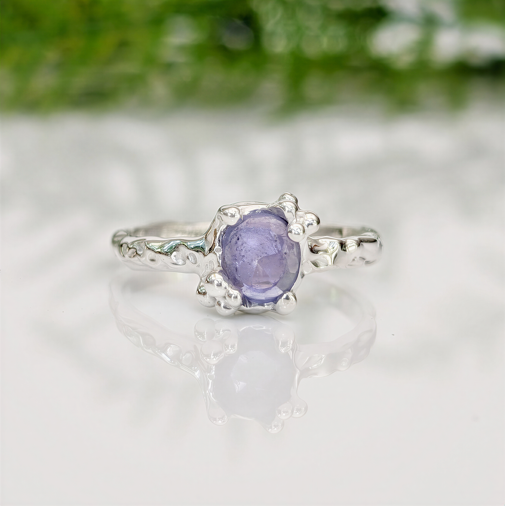 Handcrafted silver Tanzanite ring with organic texture, featuring a unique purple gemstone, ideal for meaningful gifts.
