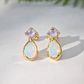 Gold stud earrings with Amethyst and Opal on a light background