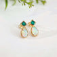Gold stud earrings with green Emerald and opal stones on a light background