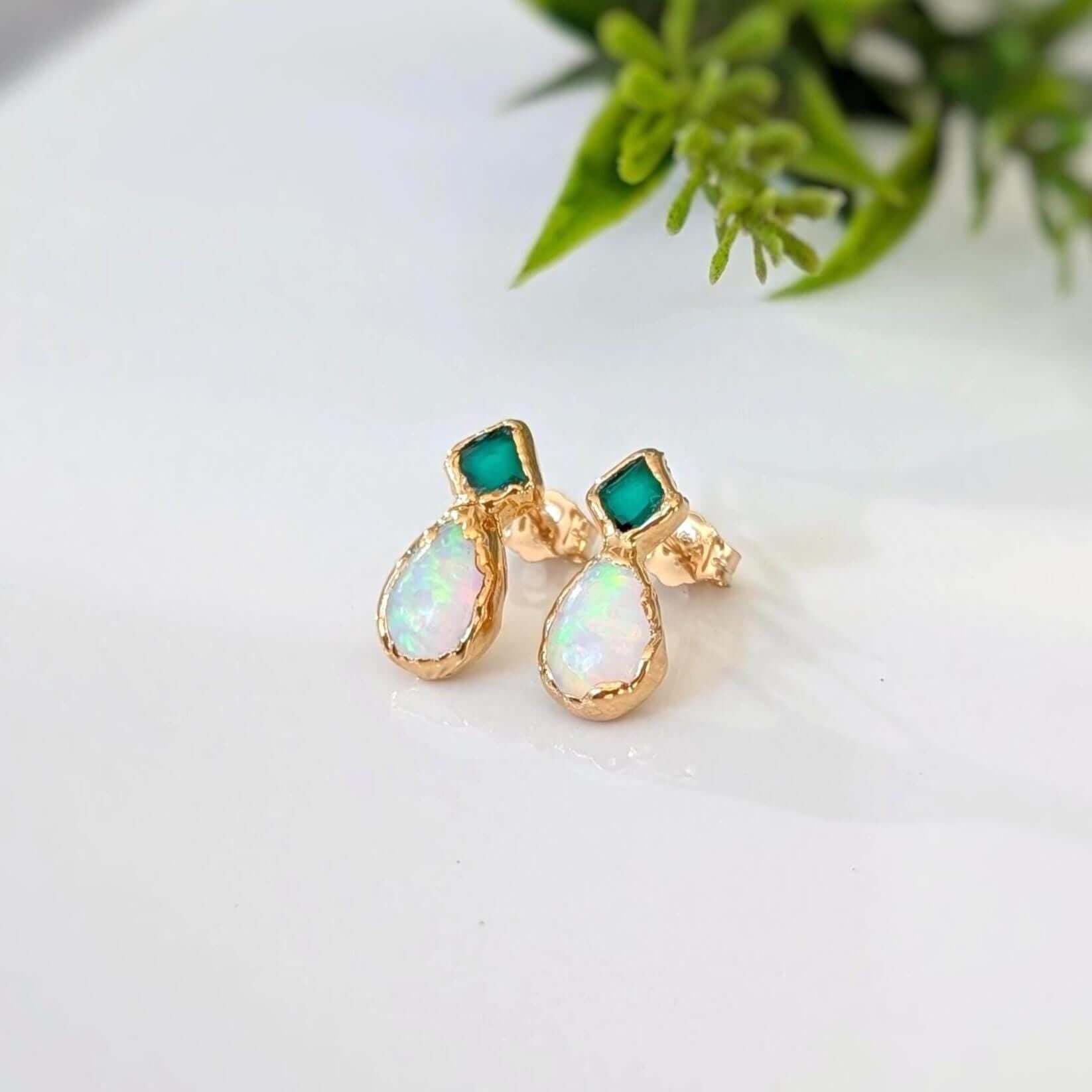 A pair of Gold stud earrings with Emeralds and Australian Opals