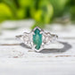Emerald and diamond engagement ring in Sterling Silver, featuring a Marquise cut emerald and salt & pepper diamonds