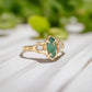Emerald and diamond engagement ring in solid 14k gold with marquise cut emerald and salt & pepper diamonds.