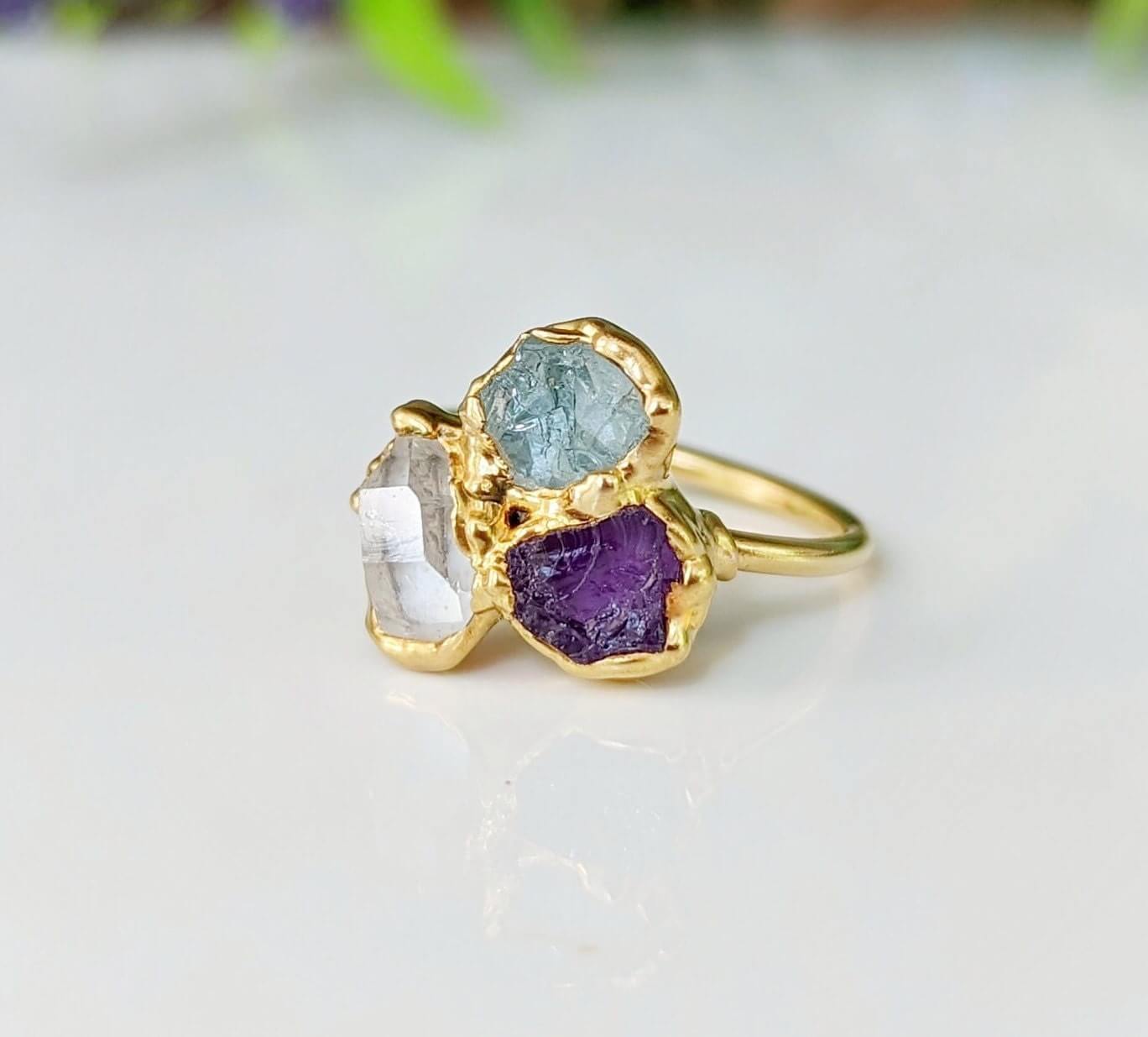 Custom family birthstone ring in gold with raw gemstones, representing loved ones' birthstones, unique heirloom jewelry.