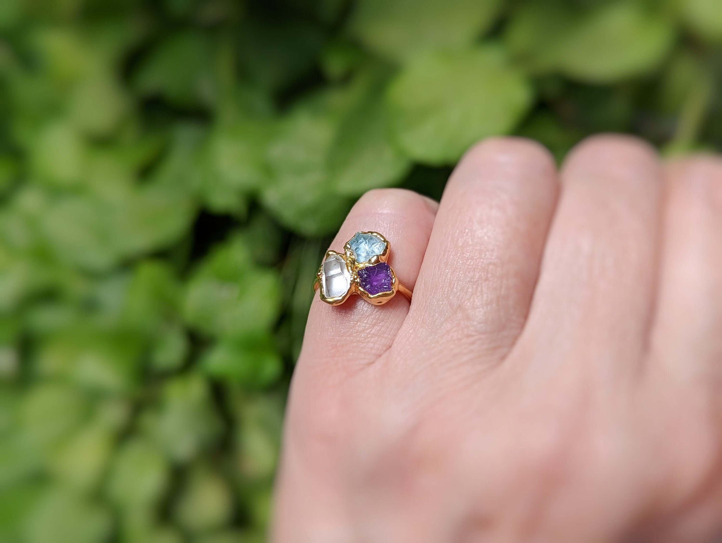 Custom family birthstone ring with raw gemstones in gold setting, showcasing love and individuality.