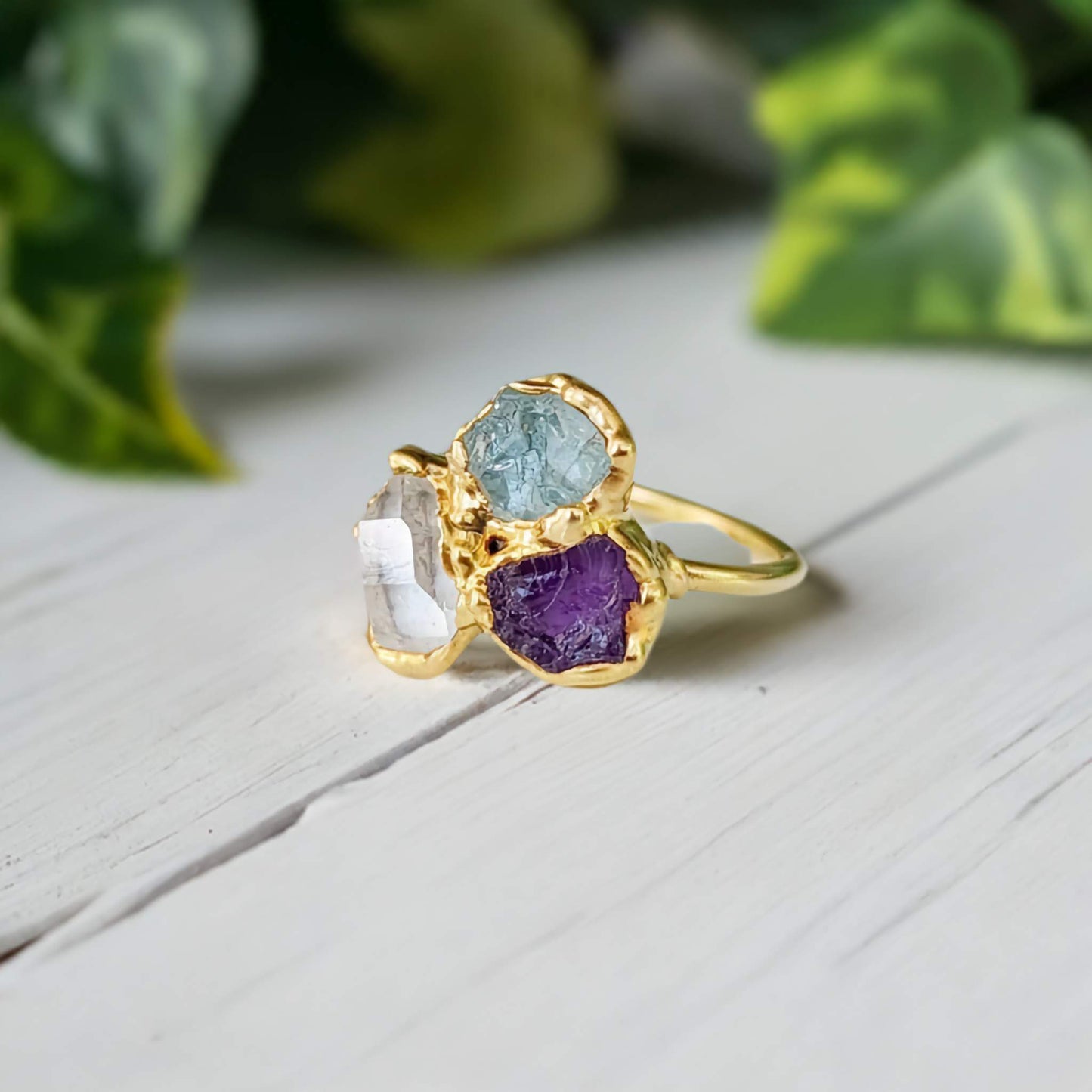 Custom family birthstone ring featuring raw gemstones in gold setting, perfect for unique heirloom jewelry.